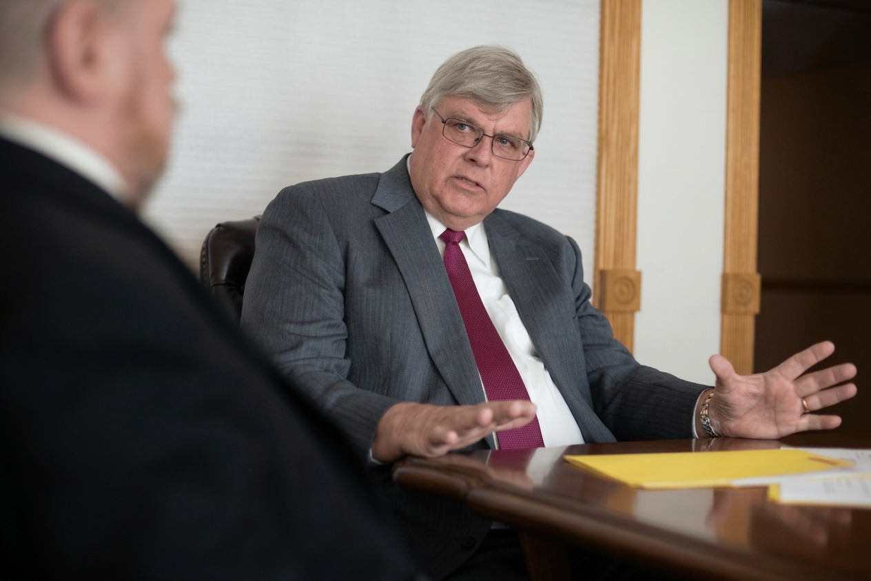 George K. Rahdert in conversation at the conference table, 2018