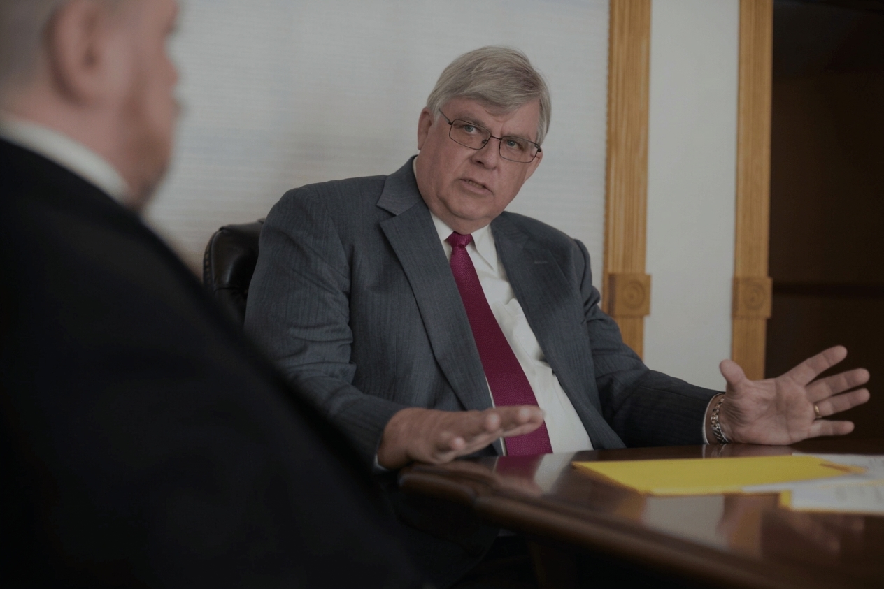 George K. Rahdert (1950–2025) in conversation at the conference table