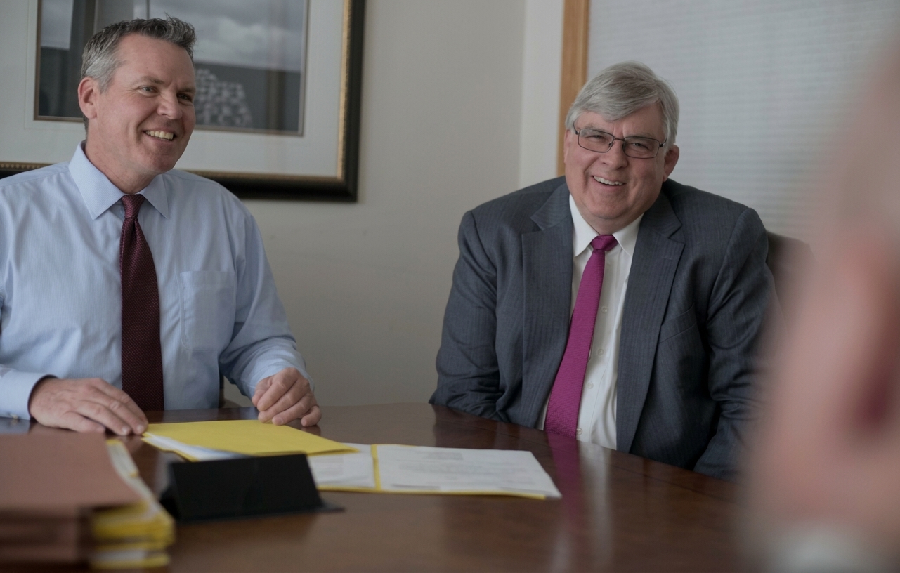 George K. Rahdert (1950–2025) and Steve Mortimer at the firm's conference table