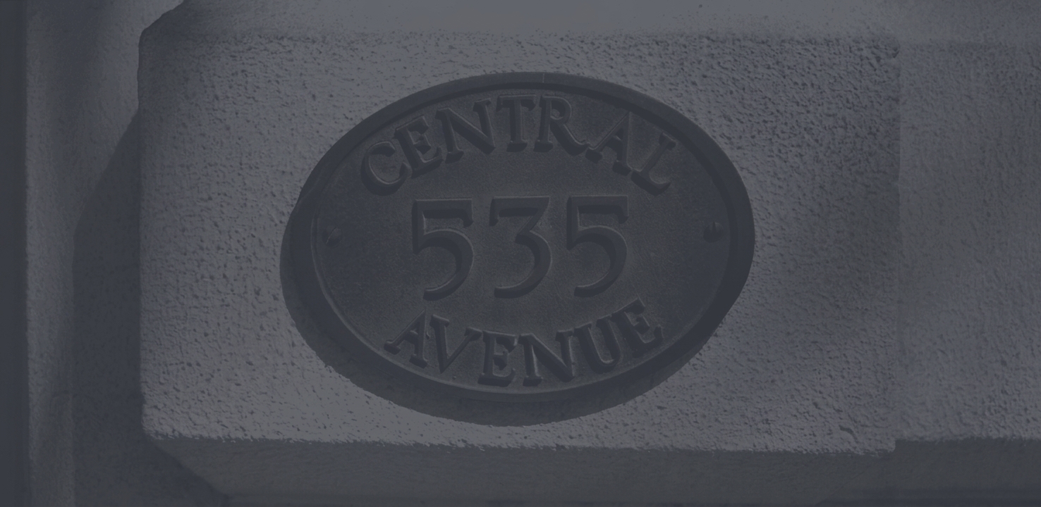 The carved stone plaque reading 535 Central Avenue on the firm's building
